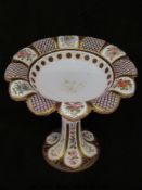 A Bohemian overlaid cranberry glass tazza with floral and scrolling gilt decoration (24.