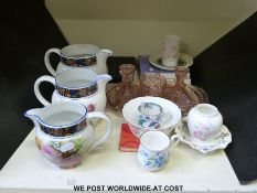 Three graduated floral jugs,