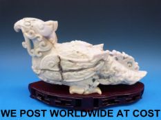 A Chinese jadeite model of an archaistic bird with scrolling chilong,