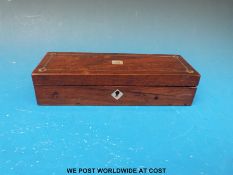 A small mahogany box with mother of pearl inlay