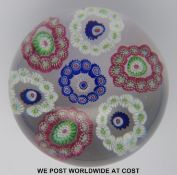 Clichy patterned millefiori glass paperweight with seven rings of multicoloured canes around