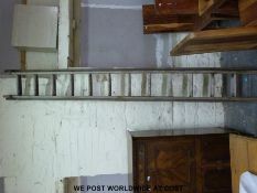 A vintage wooden extending ladler and a sack truck