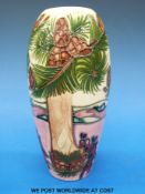 A Moorcroft vase decorated with pine trees and cones,