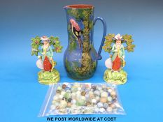 A Devon pottery jug with relief moulded parrot and two Staffordshire bocage figures and some