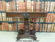 A 19thC mahogany fold over games table raised on a quatrefoil base and brass castors (W91cm)