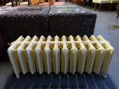 An antique low level cast iron radiator (H34 x L98 x W32cm)