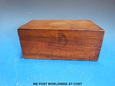 A wooden box containing wooden barrel shaped gaming counters