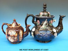 A large bargeware teapot in unusual blue glaze together with a smaller brown example