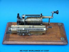 A tabletop mechanical calculator in wooden case