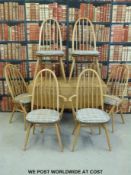 An Ercol light elm drop leaf table and six chairs including two carvers