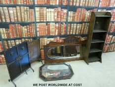 An oak bookcase, oak framed mirror, another mirror and two firescreens.