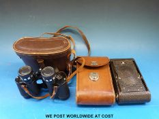 A cased pair of Hilkinson 8x30 binoculars together with a cased folding camera