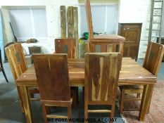 A fruitwood table and seven chairs
