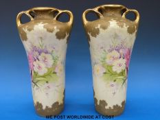 A pair of hand decorated Austrian amphora vases with floral design (height 33cm)