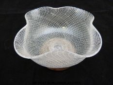 A Venetian glass bowl with latticino and control bubble decoration raised on later wooden base (5.