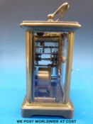 A brass cased carriage clock with keyless movement in outer box
