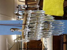 A set of three gilt metal wall mounted light shades with crystal drop lustres