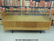 A vintage light oak shop display/haberdashery glazed counter with eight drawers under (length