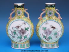 A pair of 19thC Chinese famille jaune moon flasks/ vases with bird and floral decoration on a