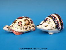 Two Royal Crown Derby paperweights, one in the form of a tortoise (with gold stopper),