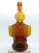 A 19thC amber glass decanter in the form of Nelson (27cm tall)
