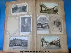 Two albums with Art Nouveau covers containing a collection of c1910-1920 postcards of scenes in