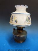 A glass oil lamp with cut glass reservoir