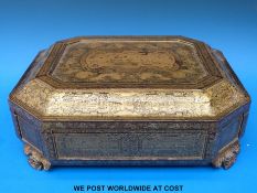 A Chinese lacquer games box decorated in gilt with figures in a court setting and dragons chasing