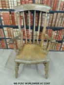 A 19thC elm seated Windsor armchair with turned spindle back