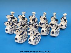 Thirteen Wilfred Gibson blue and white ceramic rocking horses with children