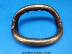 A brass tribal currency bangle