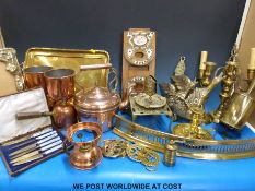 A quantity of copper and brassware including a copper kettle, chamberstick, tray, photograph frame,