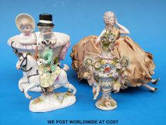 A small 19thC Meissen figure of a horseman, a German applied flower urn with putti,