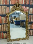 An ornate gilt framed mirror (height 143cm)