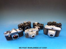 A box of approximately 20 mixed cameras including Canon, Praktica,