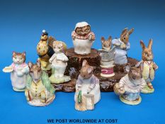 Ten Beswick Beatrix Potter figures and a base