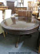A brass inlaid and carved circular Northern Indian hardwood table raised on a tripod base(height