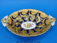 A Meissen hand painted and gilted twin handled dish with raised gilt decoration on cobalt blue