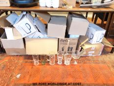 A very large collection of drinking glasses to include Coca Cola, John Smiths,