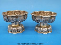 A pair of 18thC / 19thC Chinese silver salts with repousse decoration of trees and flowers (5cm