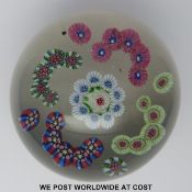 Clichy patterned millefiori glass paperweight with central pink green and white rose surrounded by