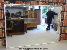 An exceptionally large bevelled mirror,
