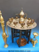 An Egyptian brass copper and white metal inlaid tray table with matching cups and coffee pot,