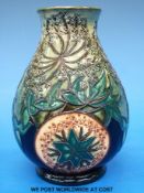 A Moorcroft pedestal bulbous vase with ivy leaf and roundel decoration,