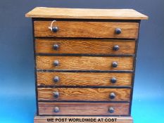 A collection of butterflies and moths in a six drawer pitch pine apprentice/collectors cabinet.