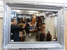 A silver framed mirror (94 x 70cm)