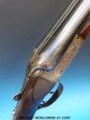 Midland Gun Company side by side shotgun with all over engraved decoration featuring scenes of dogs