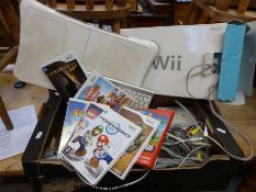 A Nintendo Wii with accessories including fit board