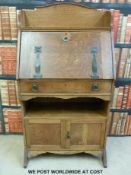 An Arts and Crafts or Art Nouveau style oak students bureau bookcase (W68 x D35 x H128cm)