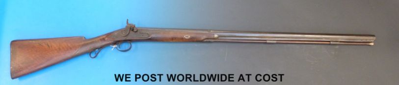 A single barrelled muzzle loading hammer action gun with engraved lock and hammer,
